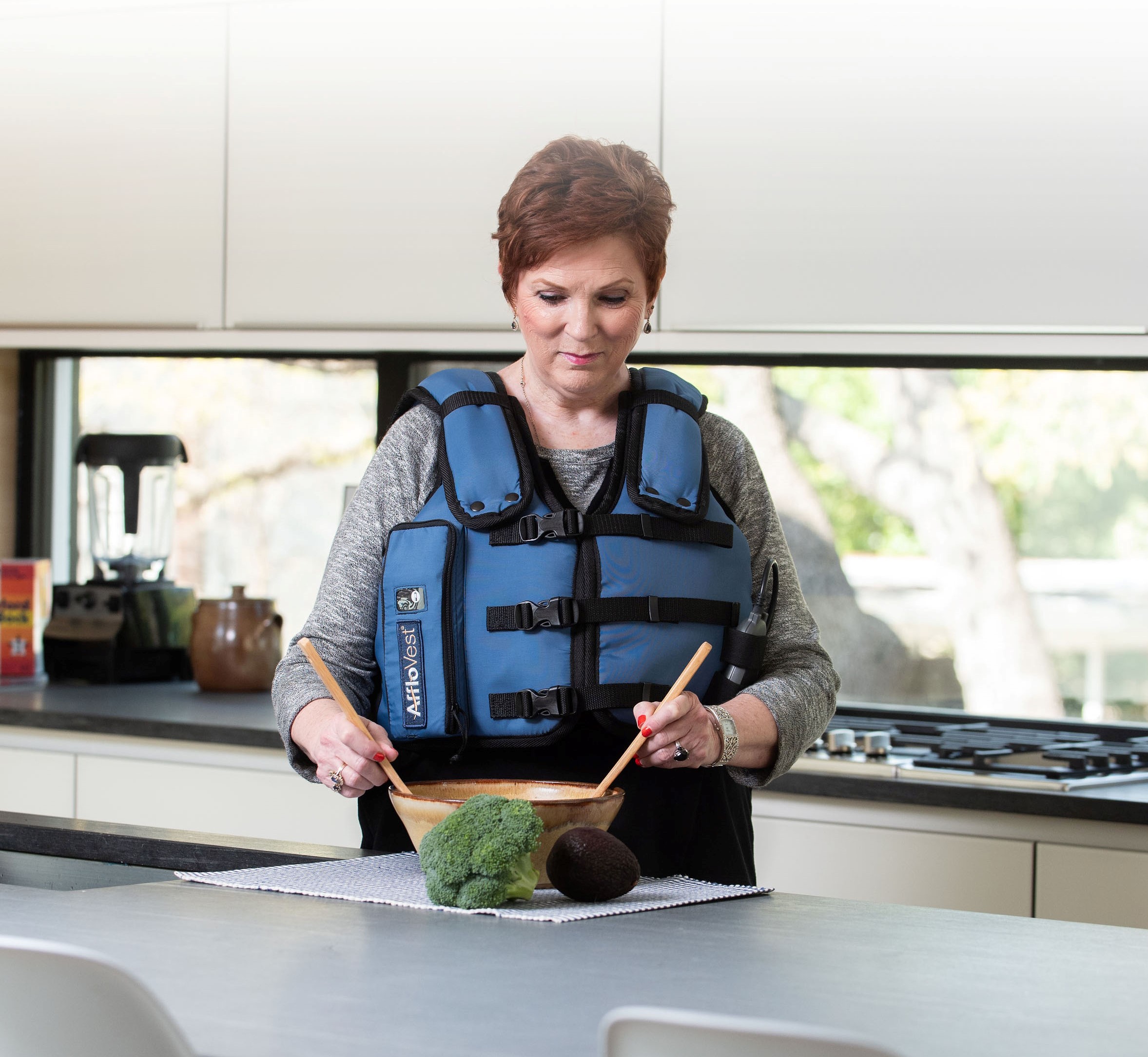 woman in kitchen using the AffloVest
