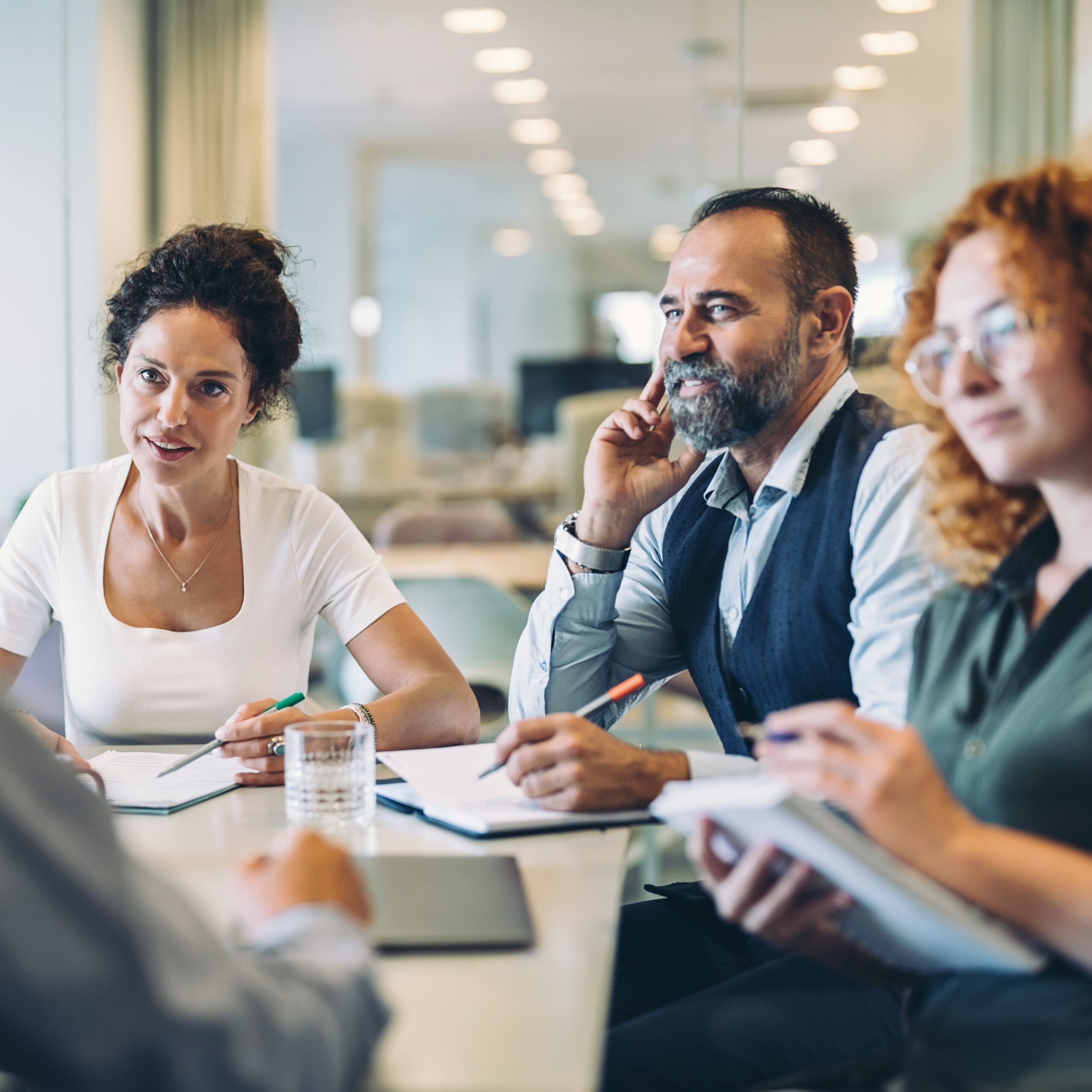 it's a business meeting with people sitting around a desk