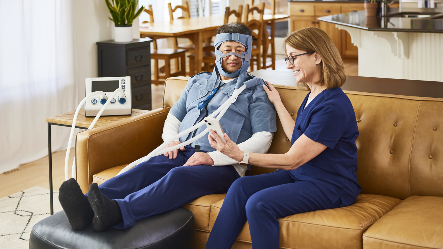 field member helping a patient understand how to use the device